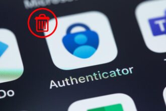 A user looking at their phone with a warning about the Microsoft Authenticator changes, urging them to export Microsoft Authenticator passwords.