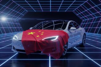 The New Model of Tesla car partially covered by a Chinese flag, symbolizing the new Tesla China AI partnership.