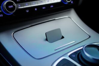 A new car's interior with a blank space on the dashboard where a feature should be, explaining what de-featuring in new cars is.