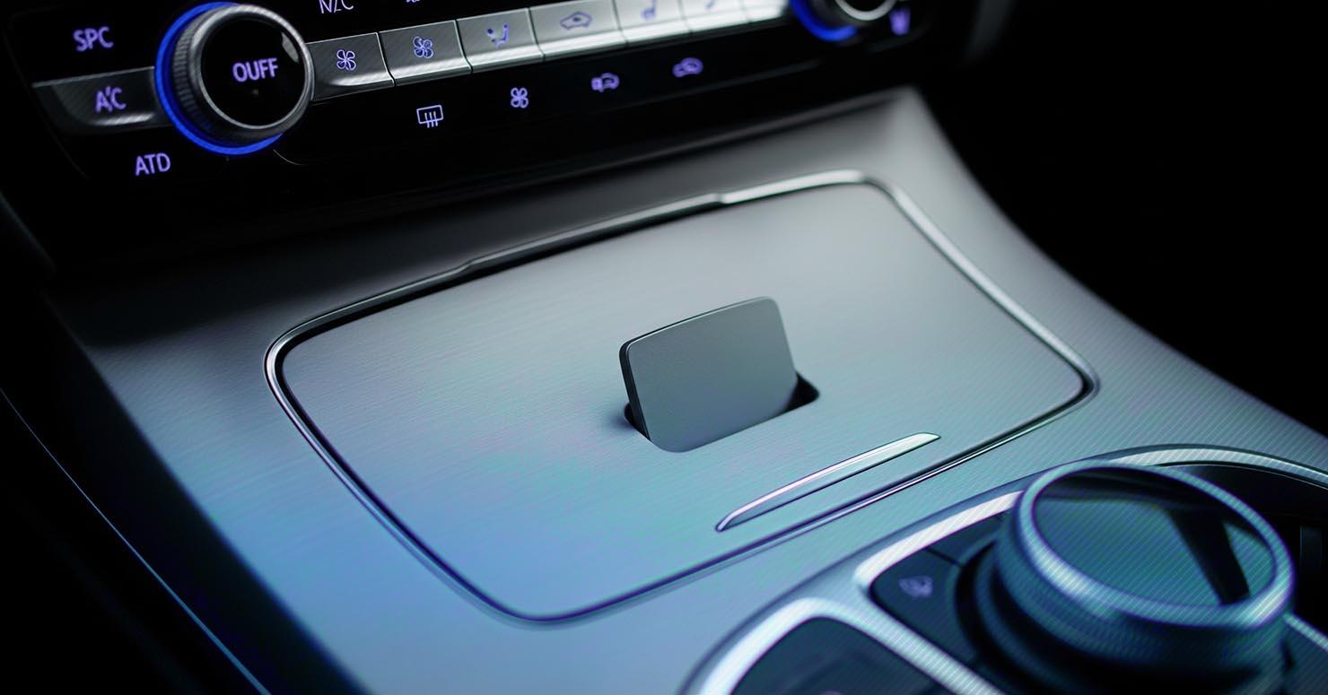 A new car's interior with a blank space on the dashboard where a feature should be, explaining what de-featuring in new cars is.
